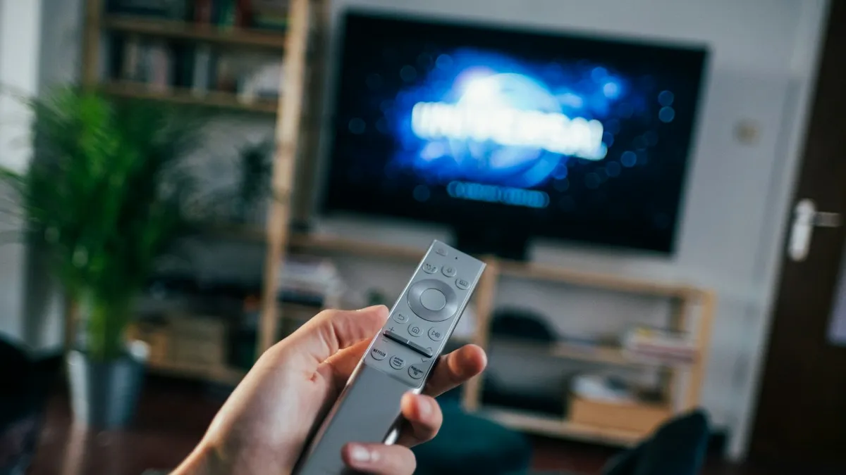 Best devices for IPTV Calgary – smart TV remote in a living room